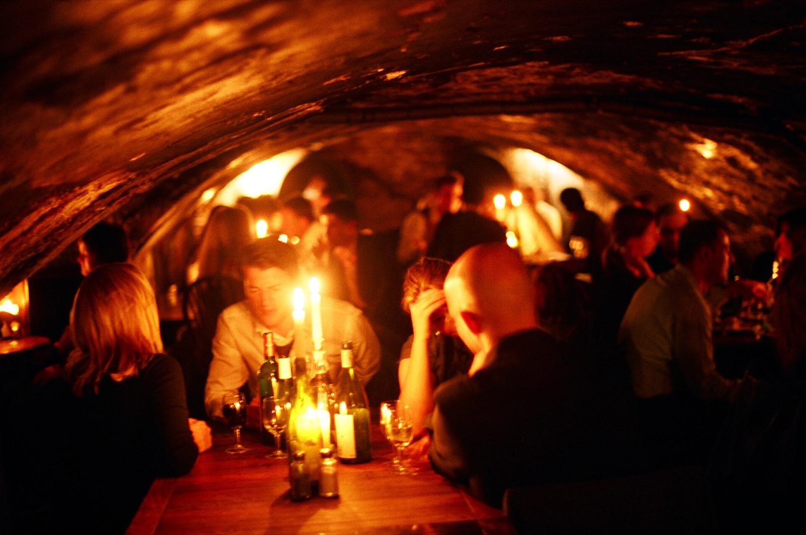 The cellar of Gordon's Wine Bar, a brick vault lit only by candles.