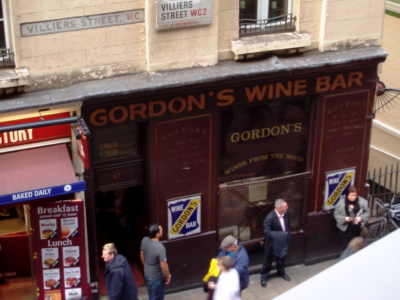 The front of Gordon's Wine Bar on Villiers Street, with its name in gold on dark wood.