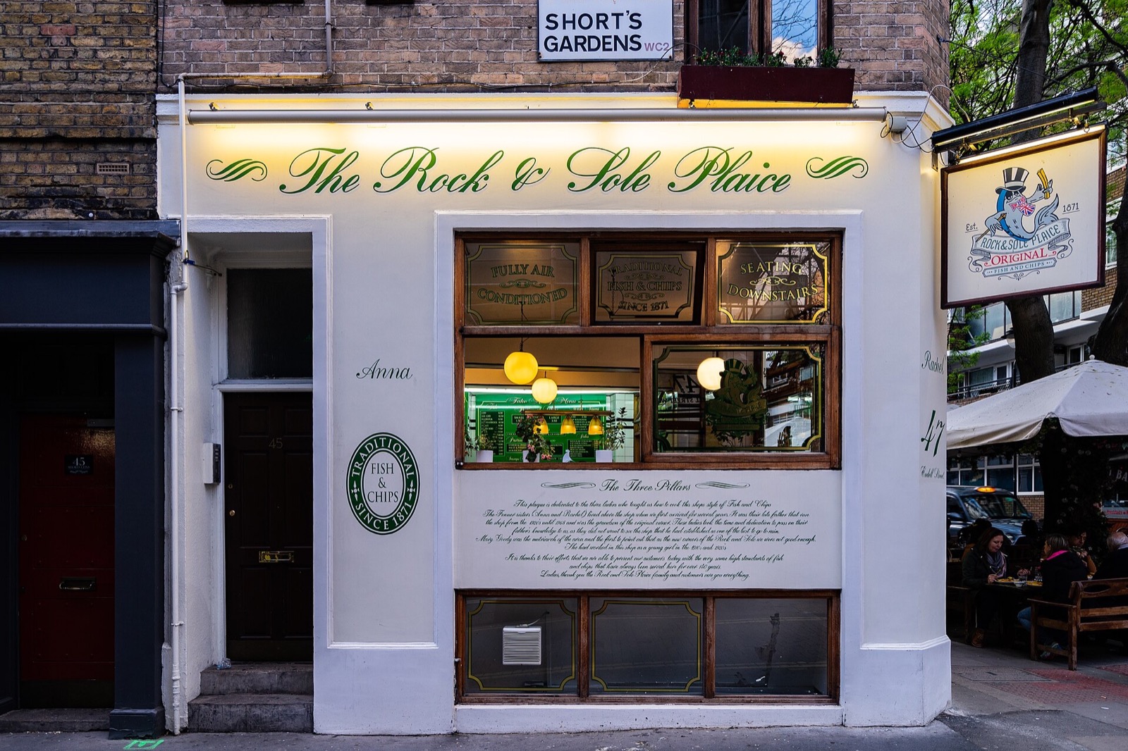 The front of the Rock and Sole Plaice on Endell Street, a small shop with its name in gold script.