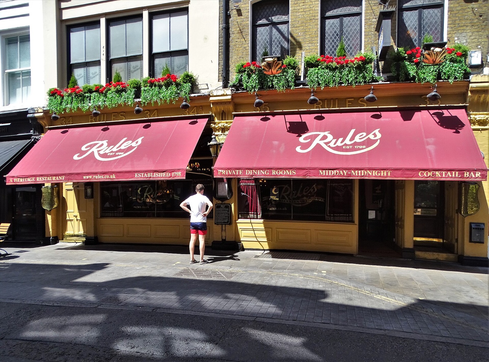Rules on Maiden Lane, its front under red awnings and window boxes.