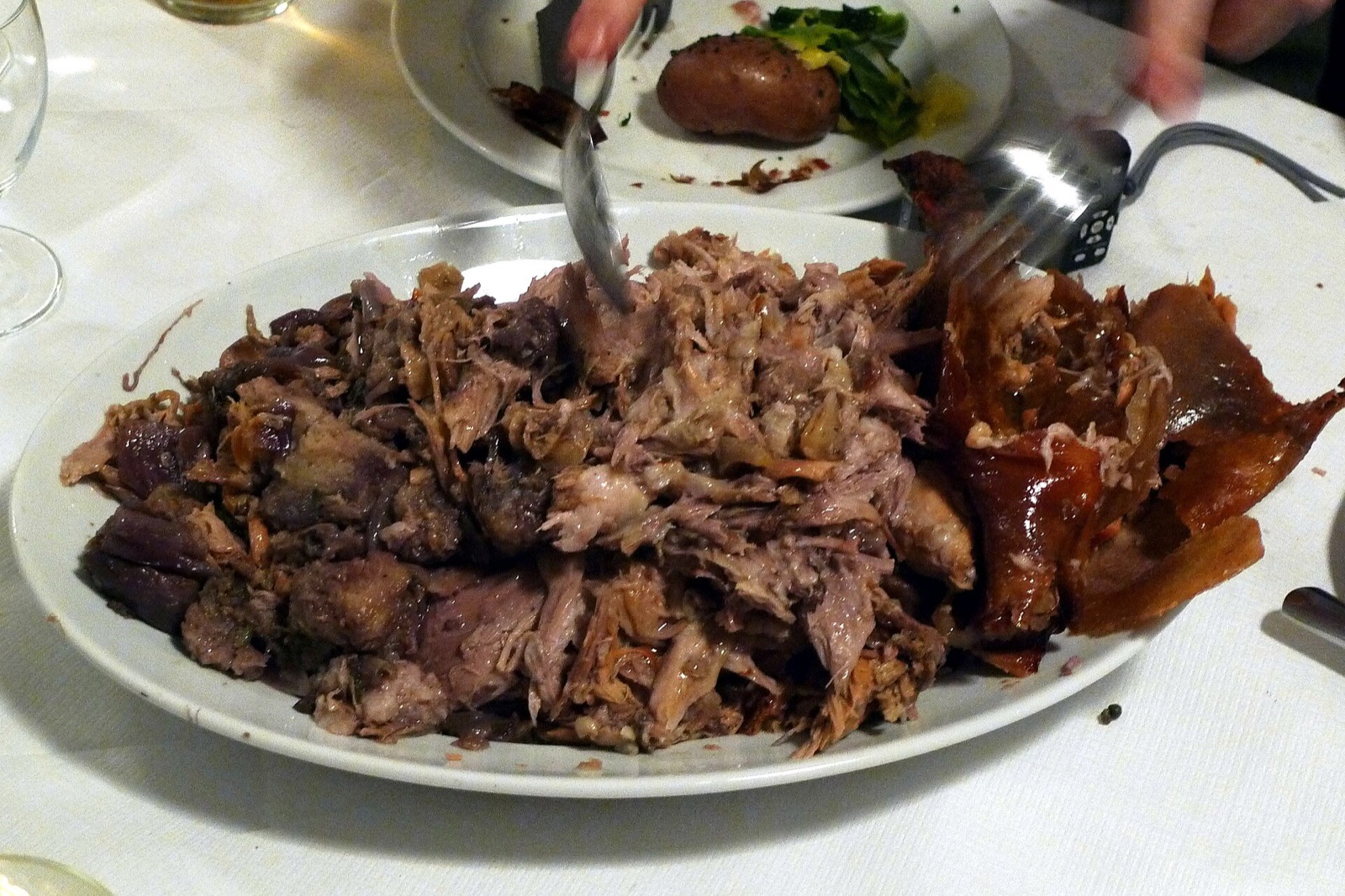 A plate of braised meat at St. JOHN, on a paper tablecloth.