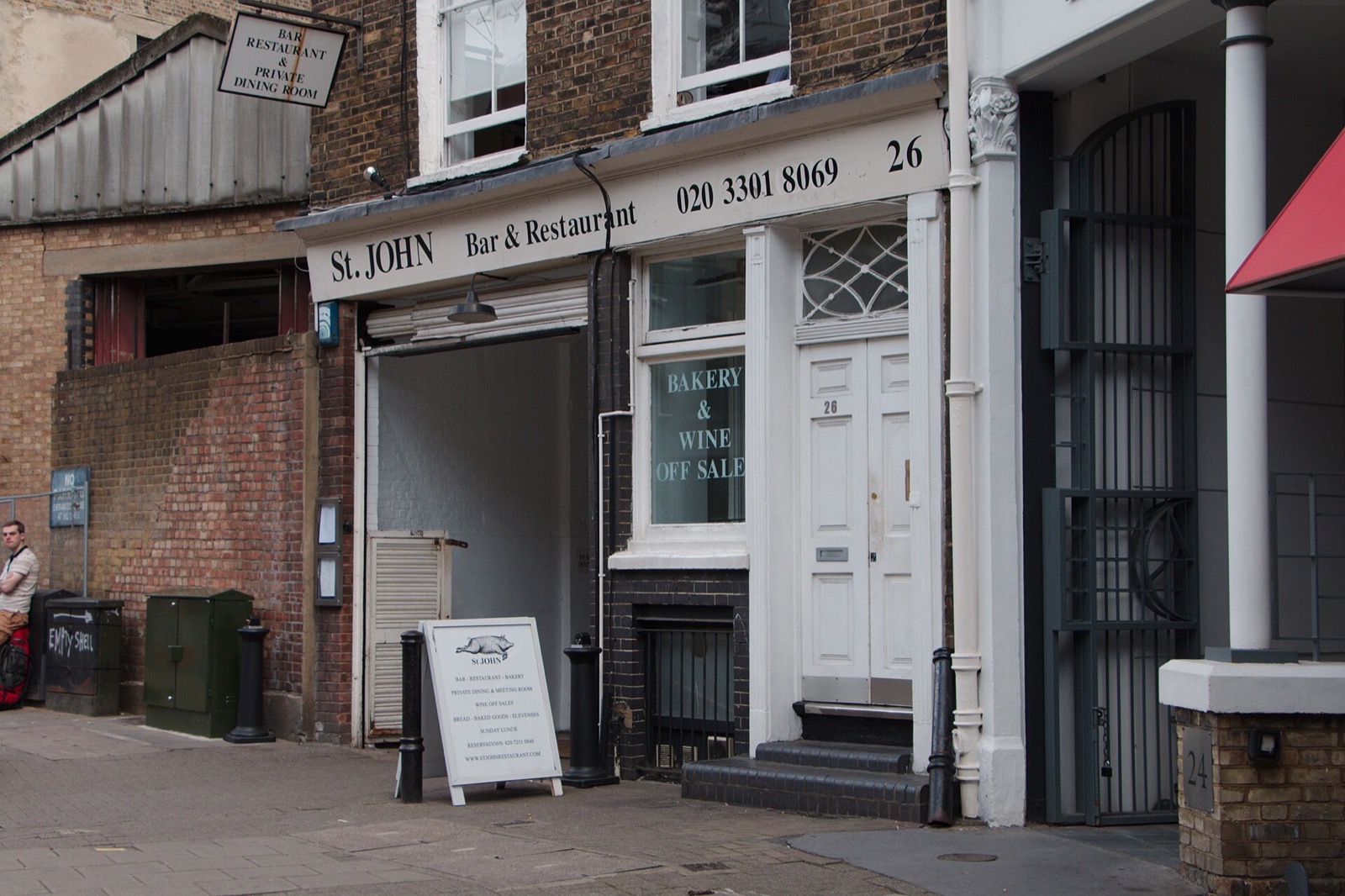 The entrance of St. JOHN in Smithfield, a plain white front on St John Street.