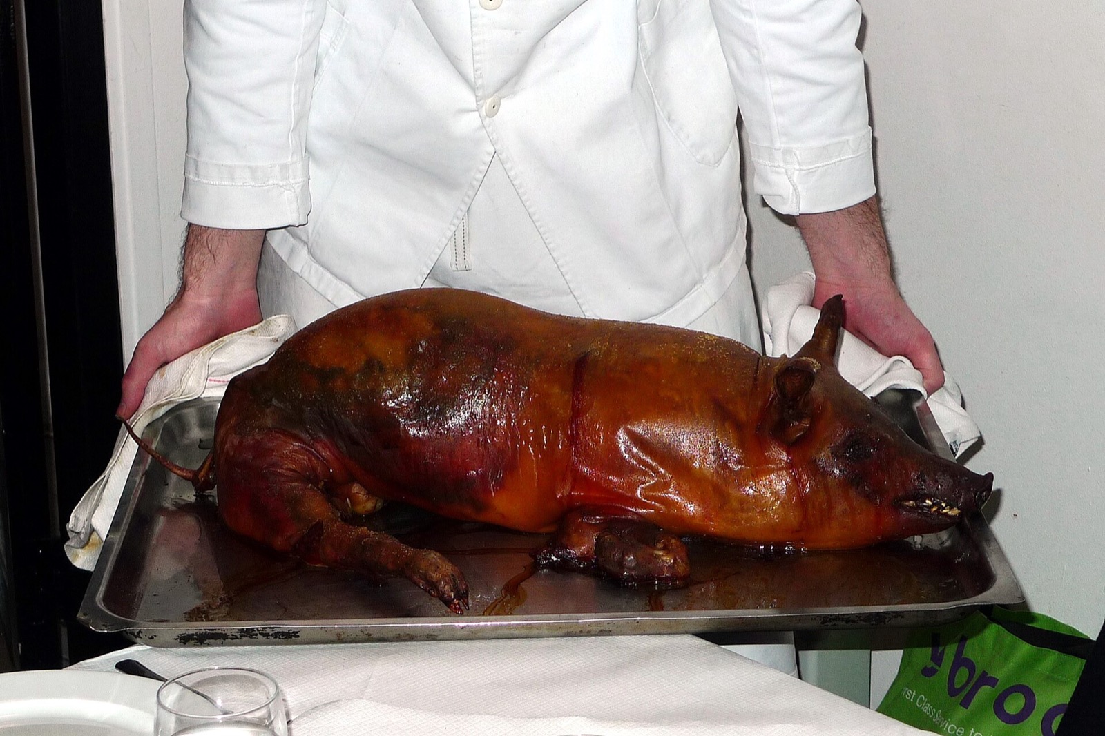 A whole roast suckling pig carried through the dining room of St. JOHN.