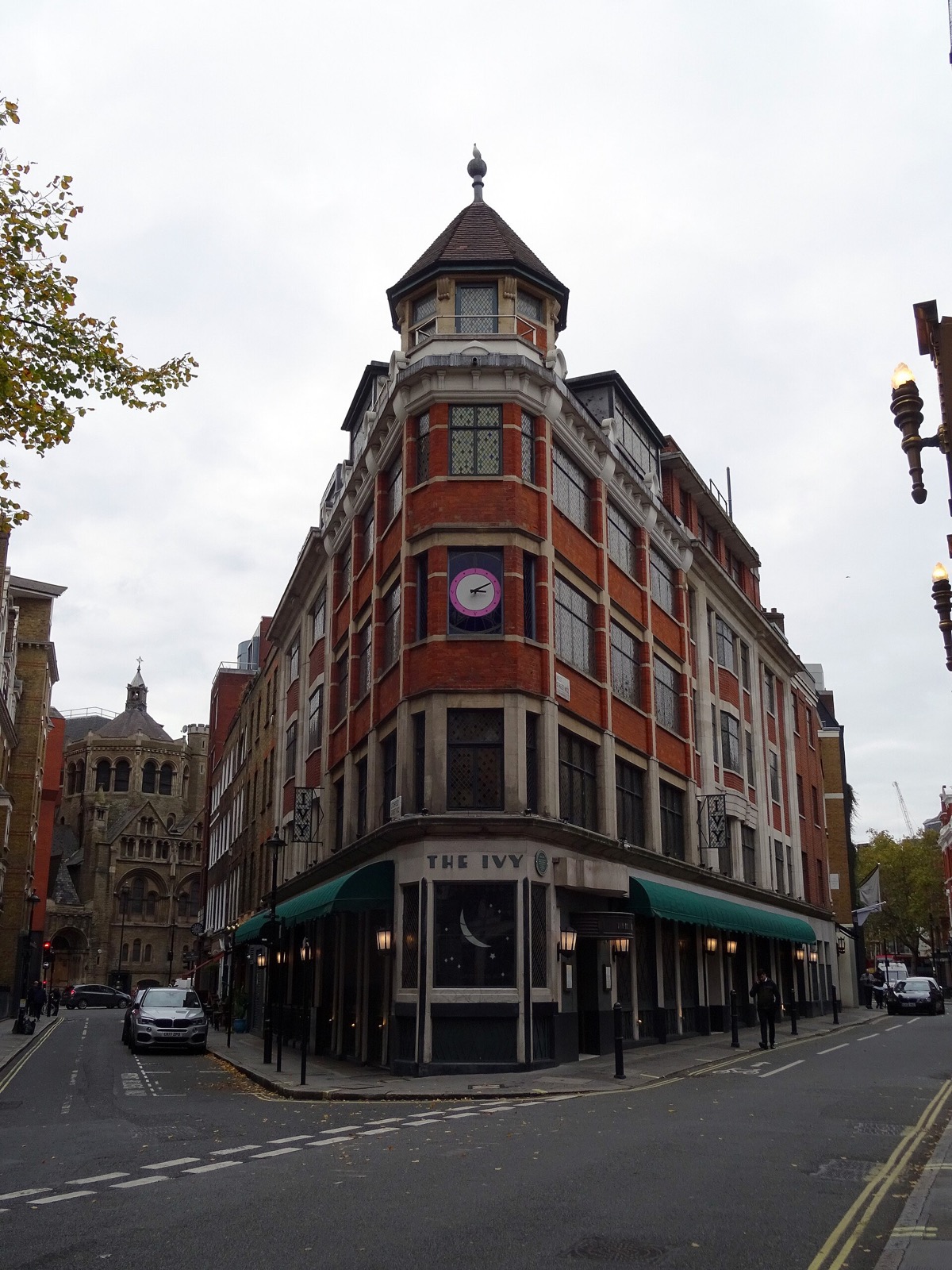 The Ivy at the corner of West Street, a red-brick building with a turret and a clock.
