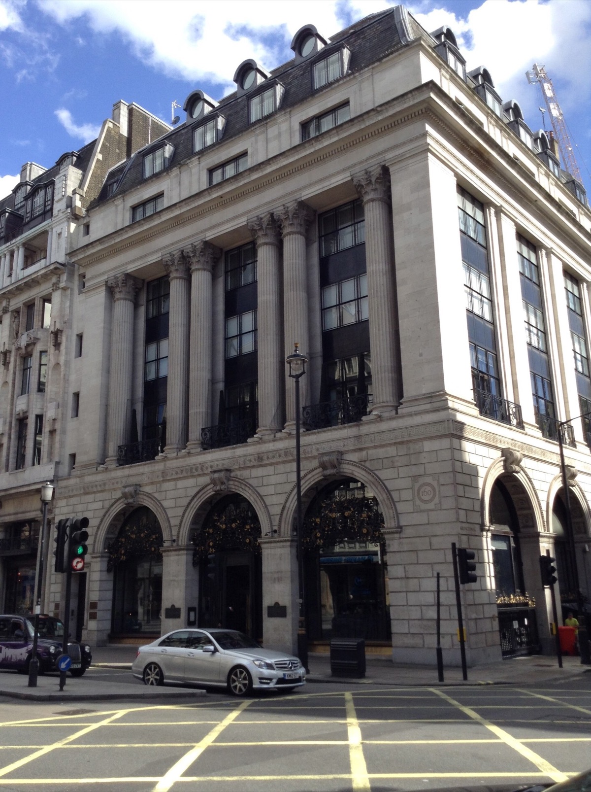 The building of The Wolseley at 160 Piccadilly, three tall arches under columns.