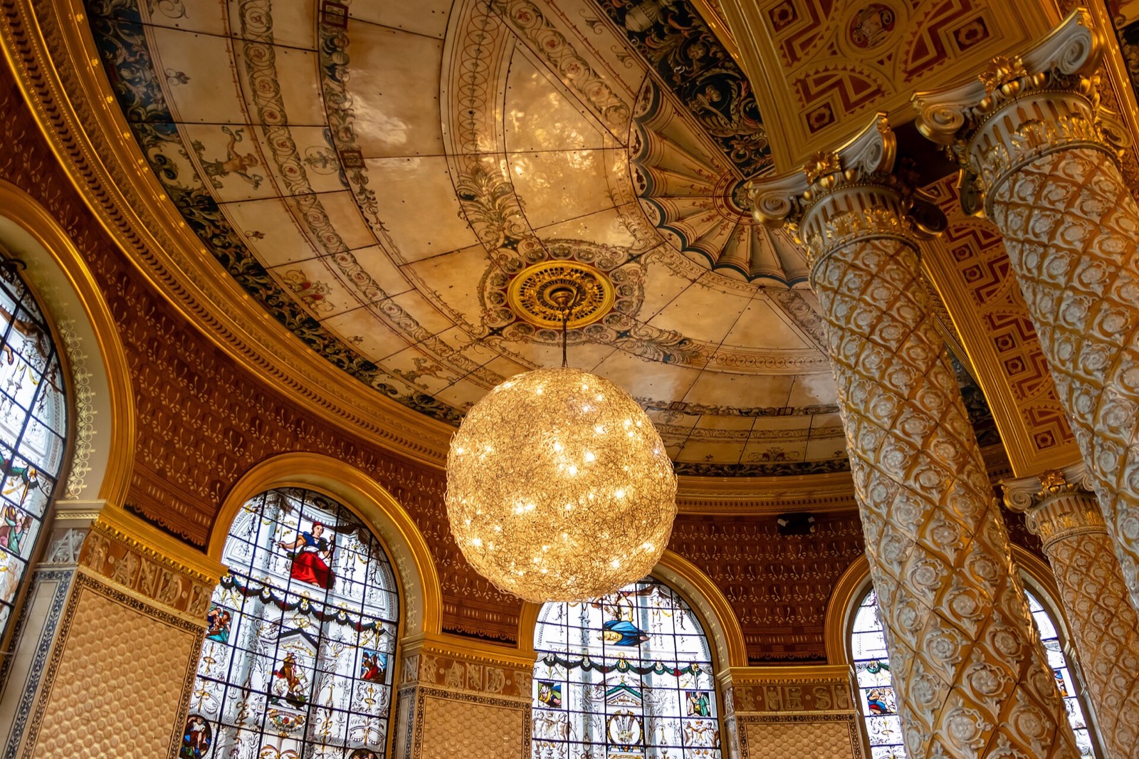 The enamelled ceiling and globe lamps of the Gamble Room at the V&A.