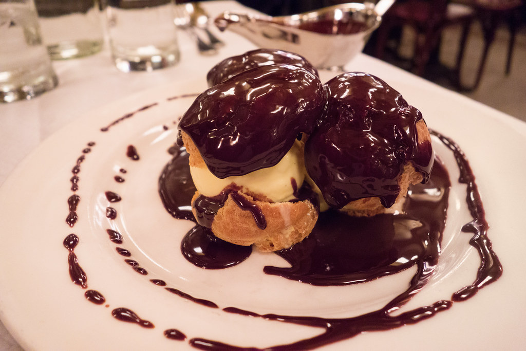 Profiteroles covered in chocolate sauce at Balthazar.