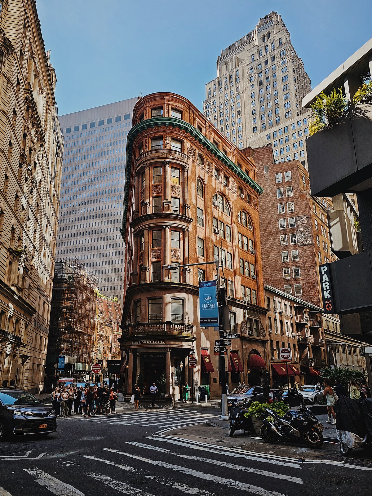 The rounded corner of Delmonico's, eight floors of brick and stone.