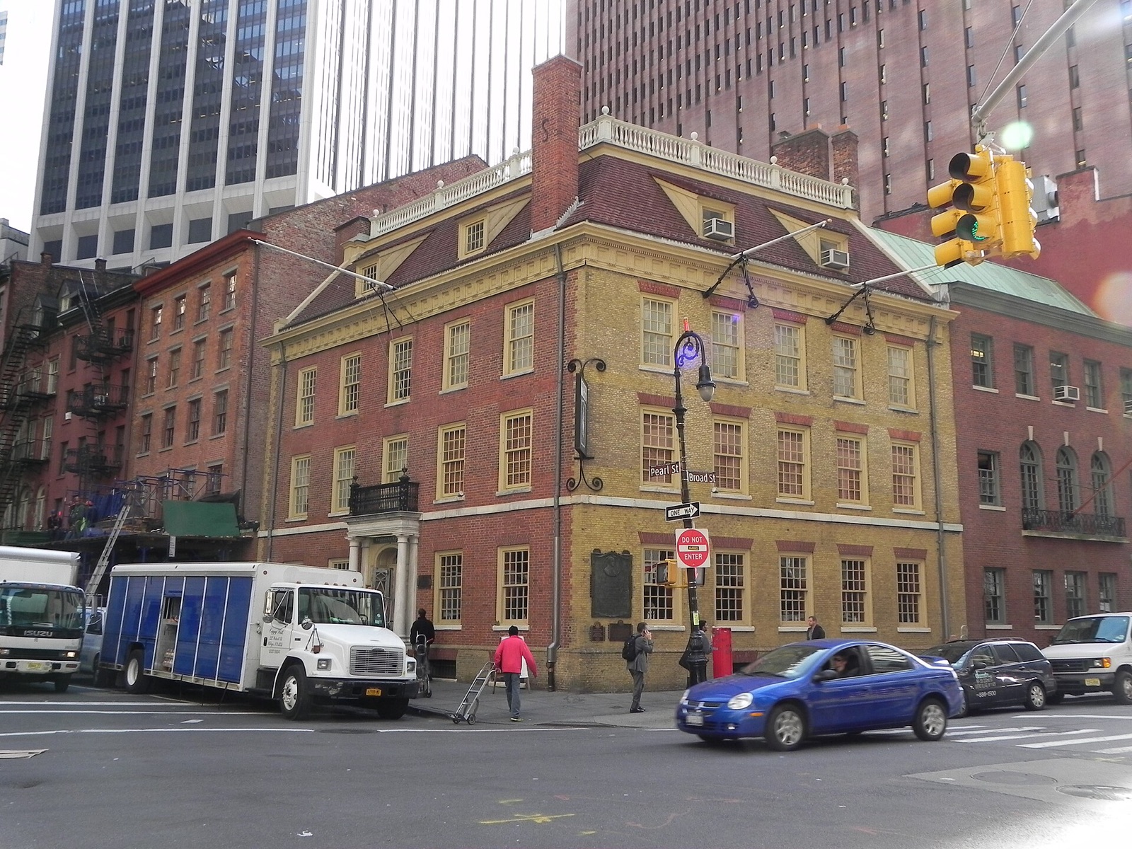 Fraunces Tavern and its neighbours, low brick houses under the towers of the Financial District.