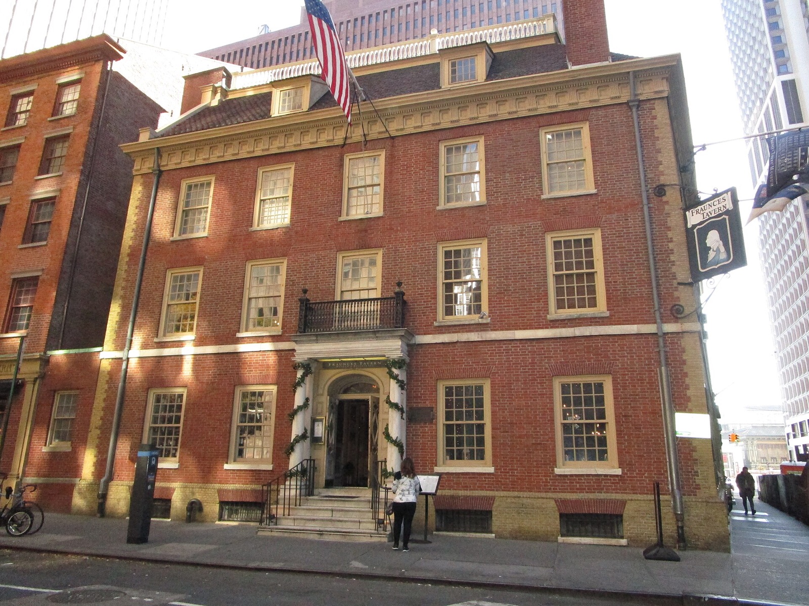 Fraunces Tavern, a brick house of the eighteenth century with a flag over its door, at the corner of Pearl and Broad Streets.
