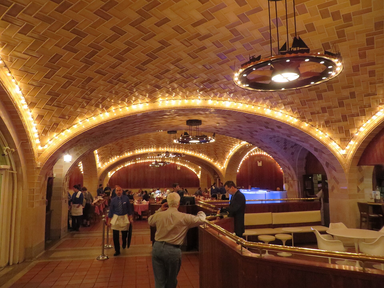 A dining room of the Grand Central Oyster Bar under its tiled vaults, outlined in small lights.