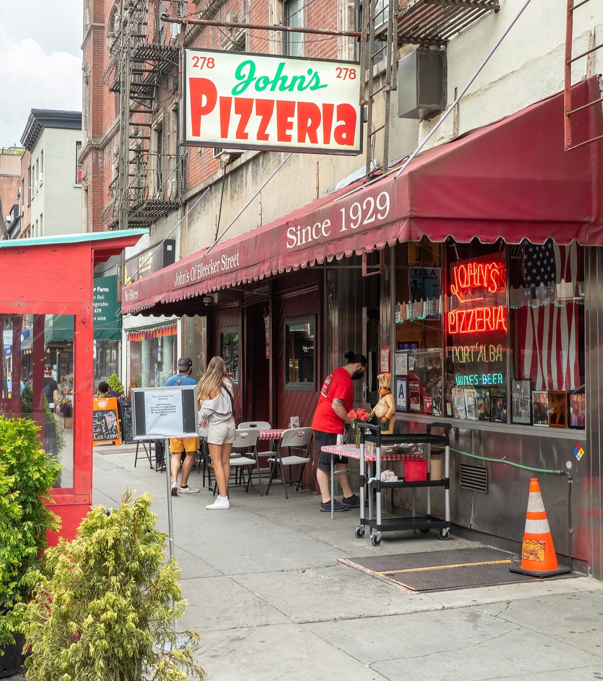 The sign of John's Pizzeria over its door on Bleecker Street.