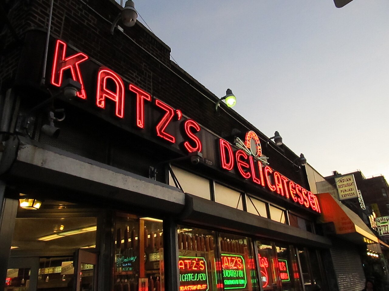 The neon sign of Katz's Delicatessen at dusk.