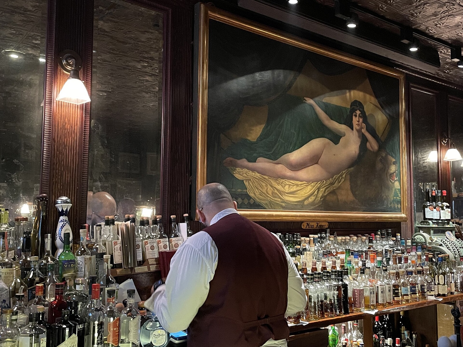 The bar at Keens Steakhouse, with a large painting of a reclining nude above it.