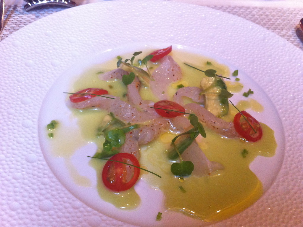 Thin slices of raw fluke in a pale green broth at Le Bernardin.