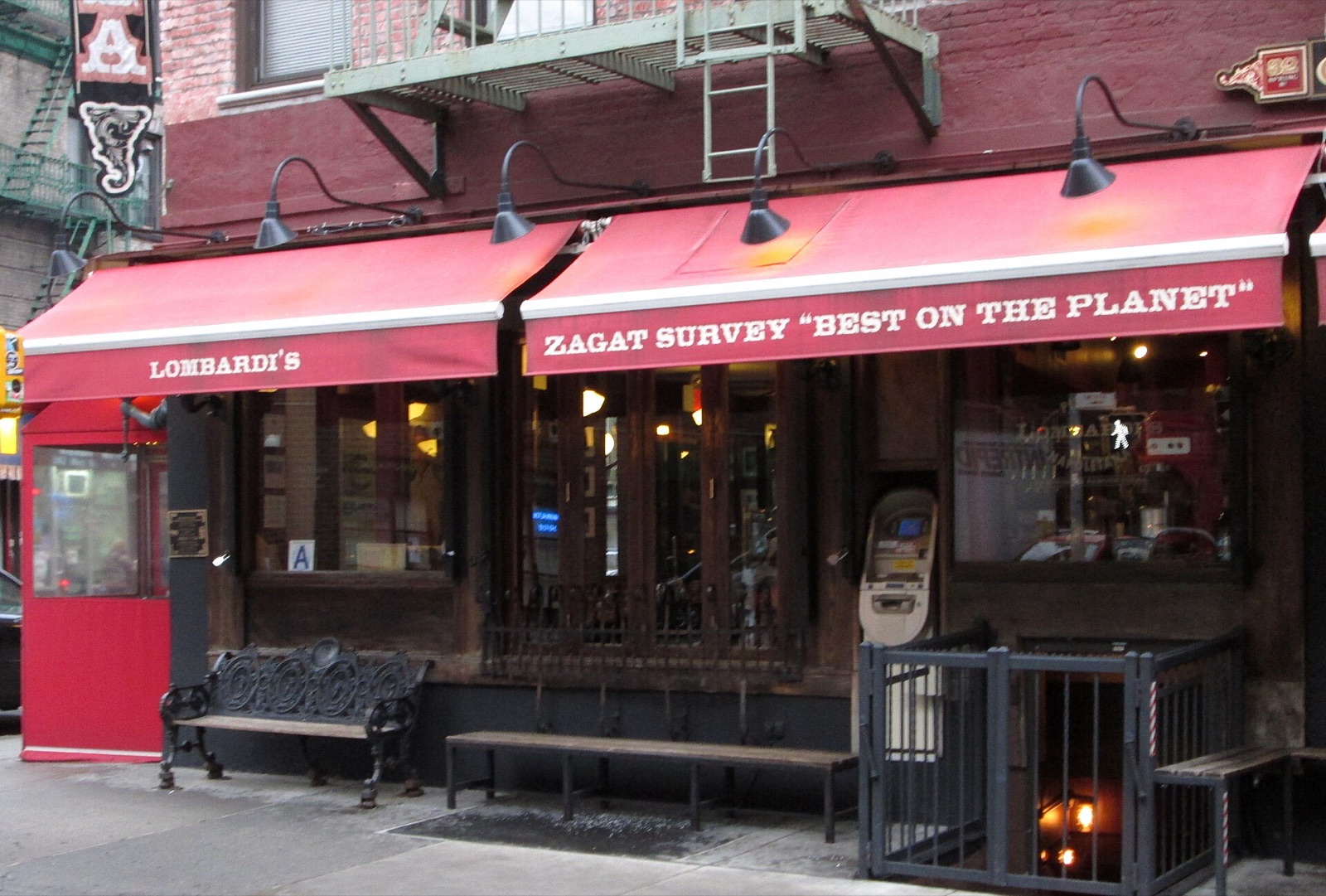The front of Lombardi's on Spring Street, under a red awning.