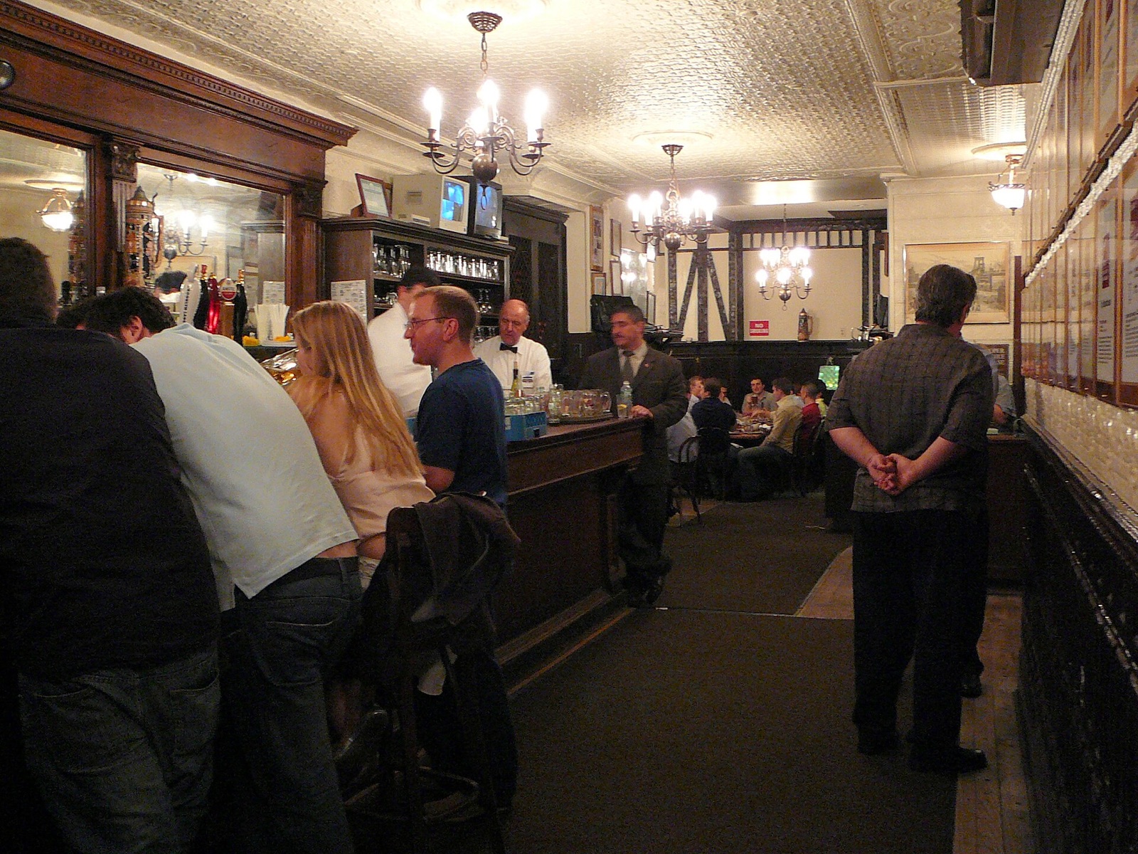 The long wooden bar at Peter Luger, with customers waiting for their tables.