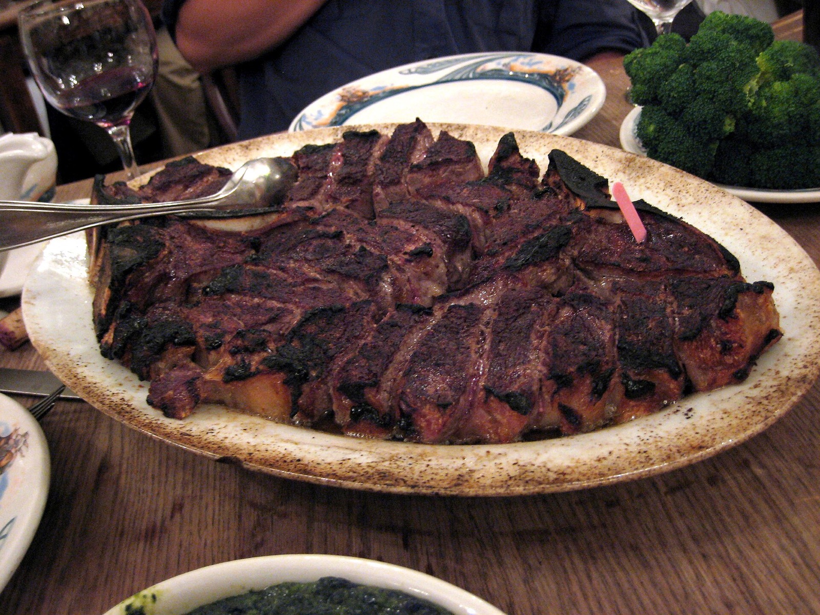 A sliced porterhouse steak on a plate at Peter Luger.