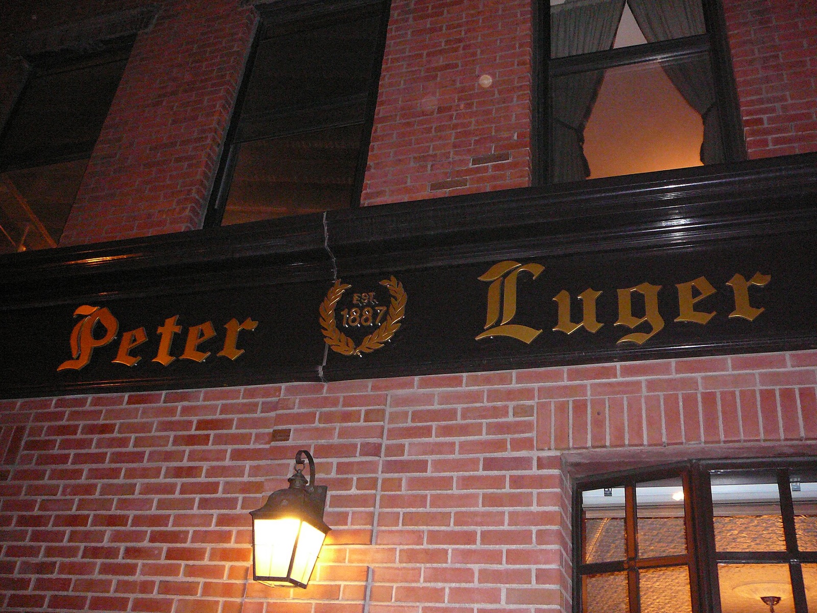The name of Peter Luger in old lettering on its brick wall.