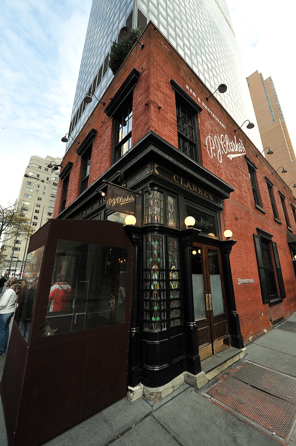 The corner of P.J. Clarke's seen from the street, dwarfed by the tower behind it.