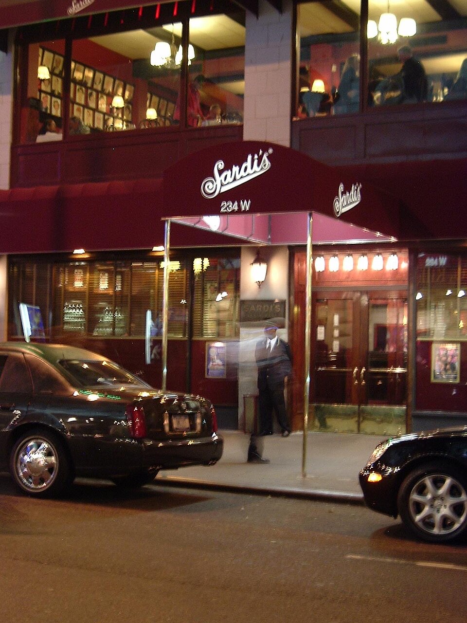 The canopy of Sardi's at night, with a car at the kerb.