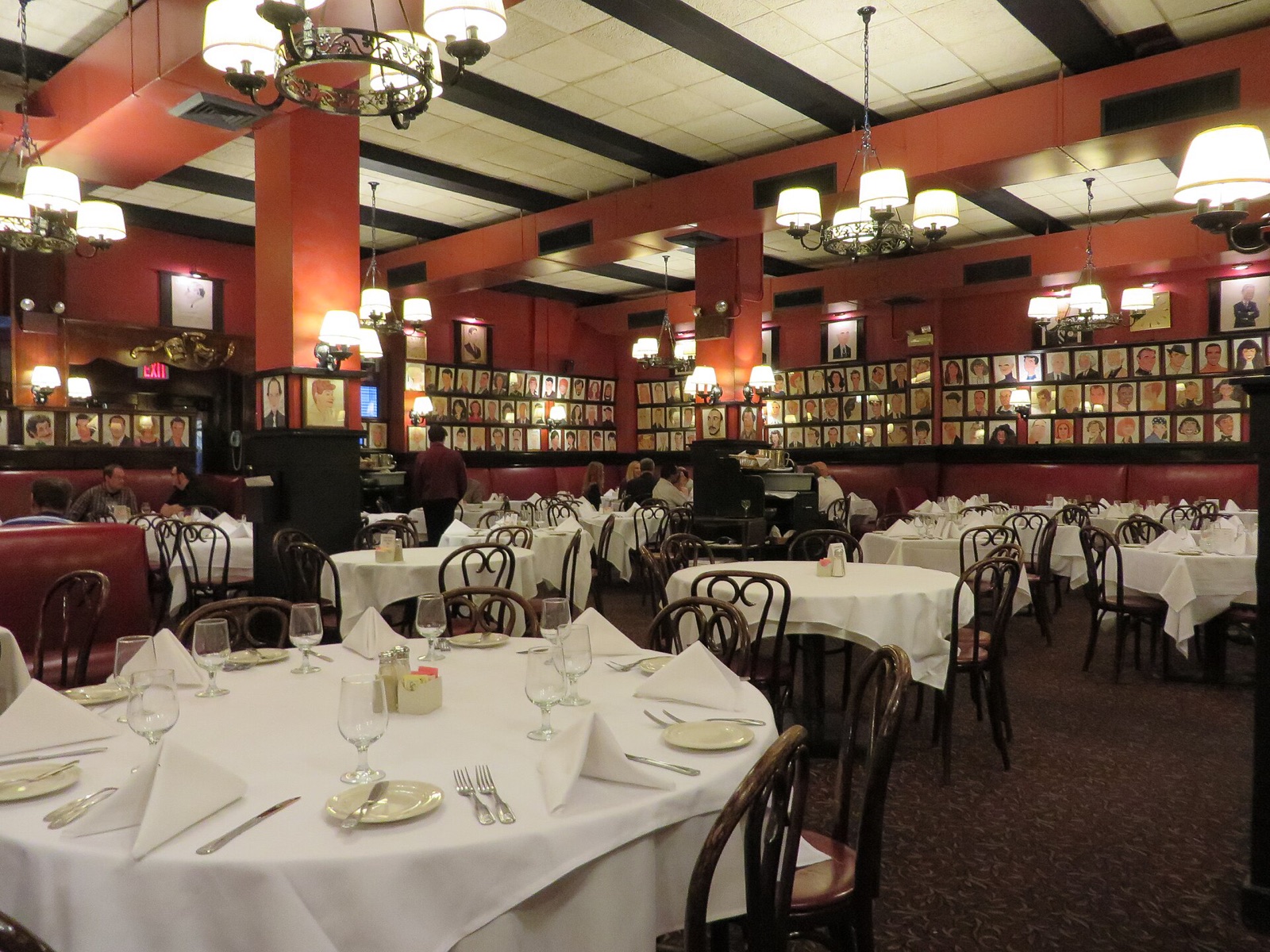 The dining room at Sardi's, its walls lined with framed caricatures.