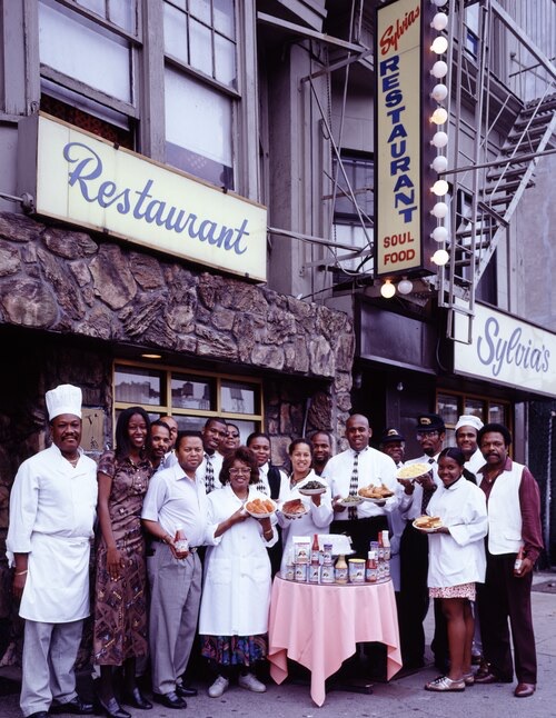 The staff of Sylvia's standing outside the restaurant, in a photograph by Carol M. Highsmith.