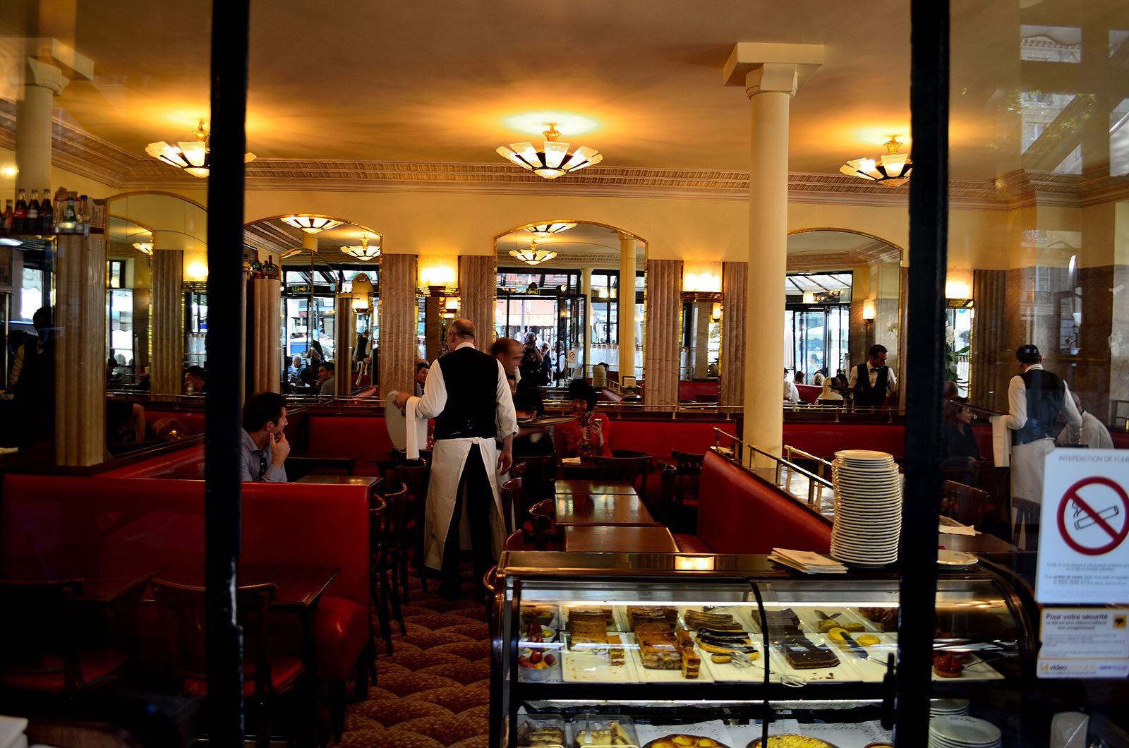 The inside of the Café de Flore, red banquettes and mirrors.