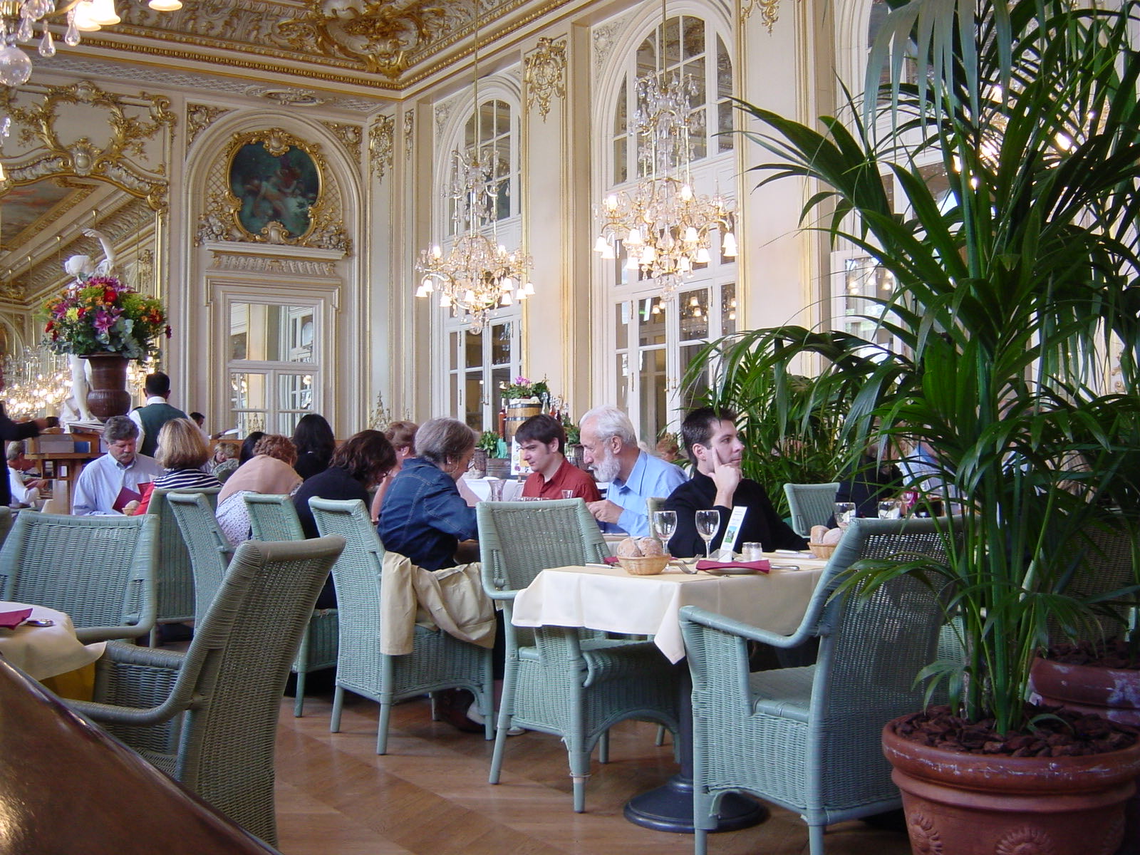 The restaurant of the Musée d'Orsay, a gilded dining room with chandeliers, painted ceilings and tall windows.