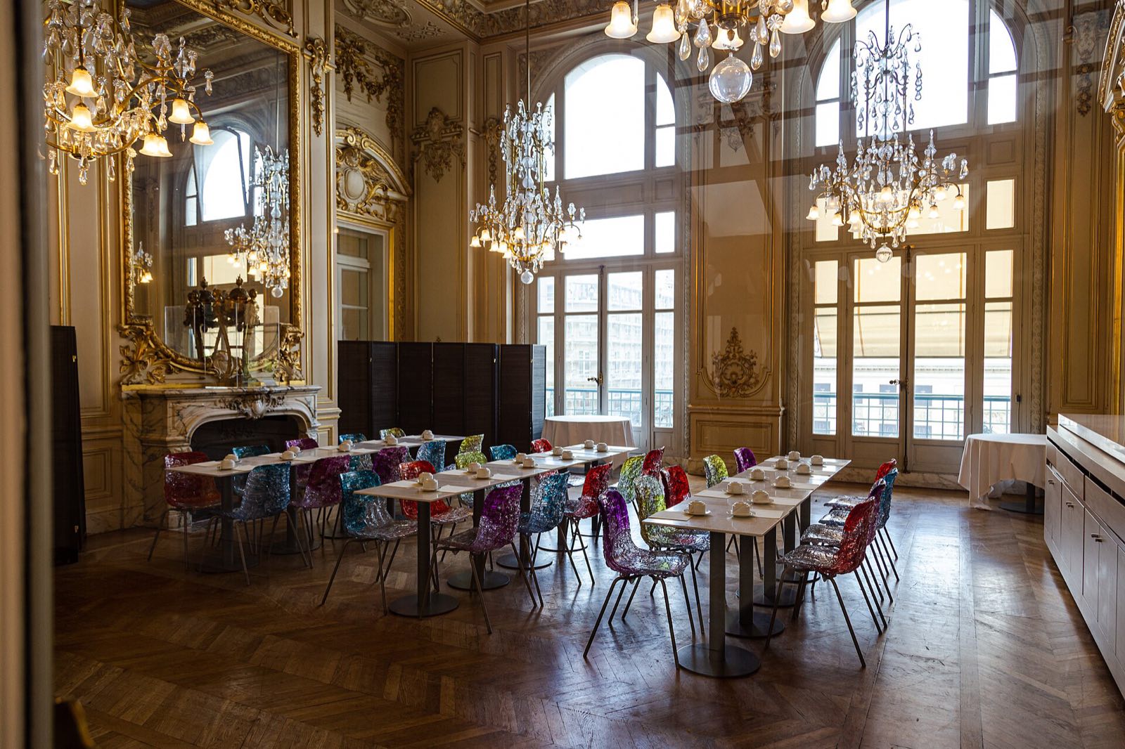 A gilded room of the restaurant of the Musée d'Orsay, laid for a meal.
