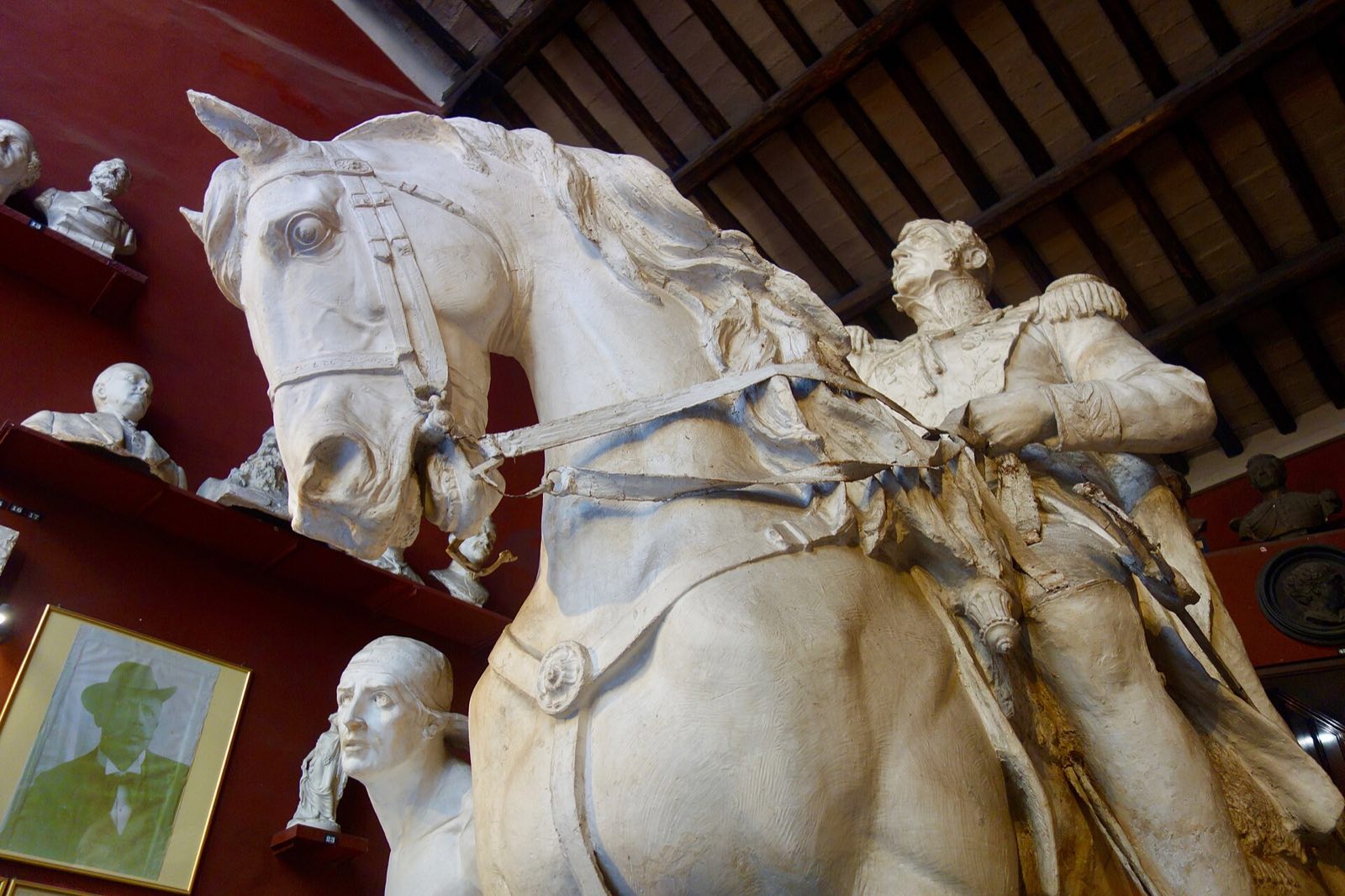A plaster horse and rider towering over the room at Canova Tadolini.