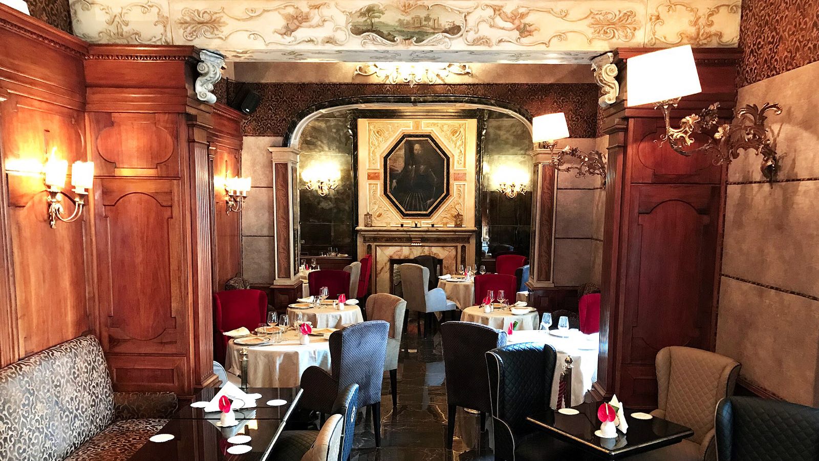 The panelled dining room of Harry's Bar in Rome, with white tablecloths.