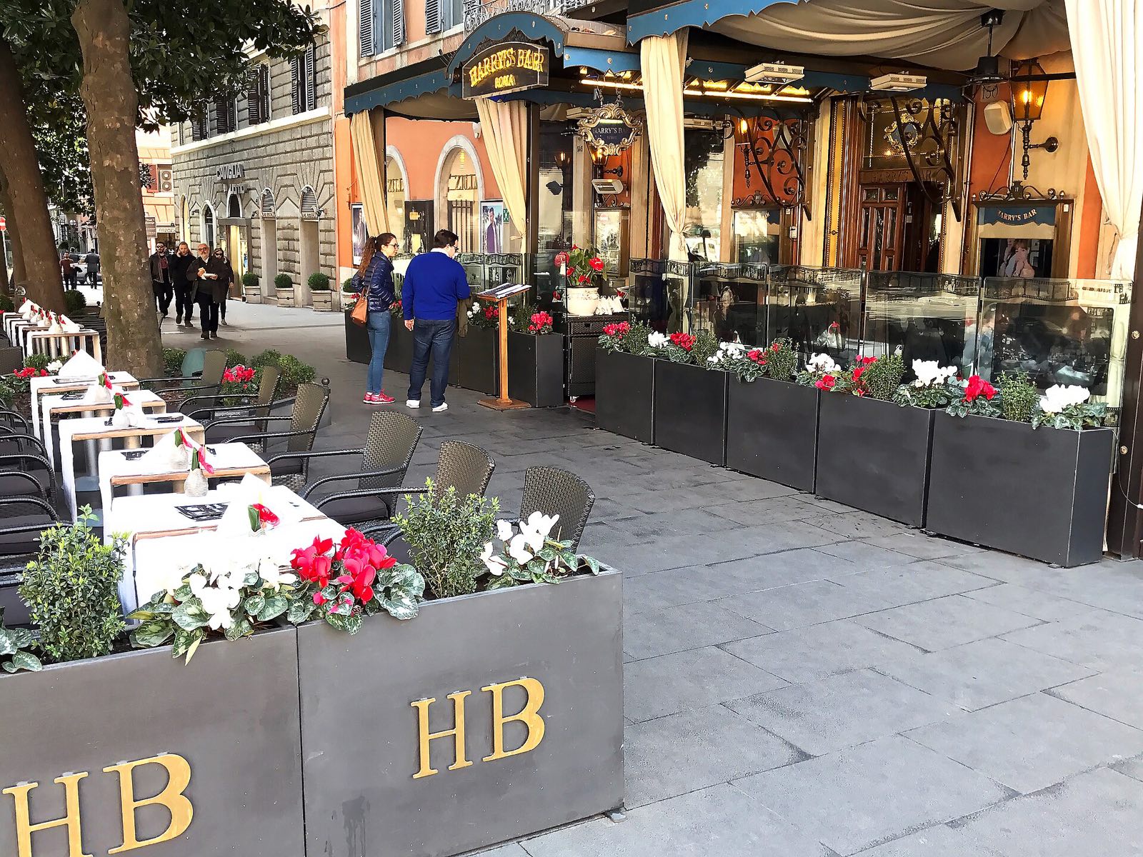 The terrace of Harry's Bar on Via Veneto, with flowers along the pavement.