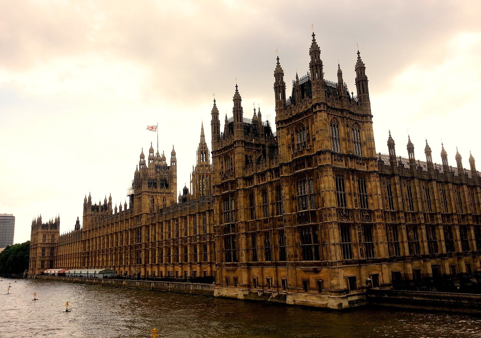 The Houses of Parliament at dusk from Westminster Bridge, a long Gothic front rising straight from the Thames.