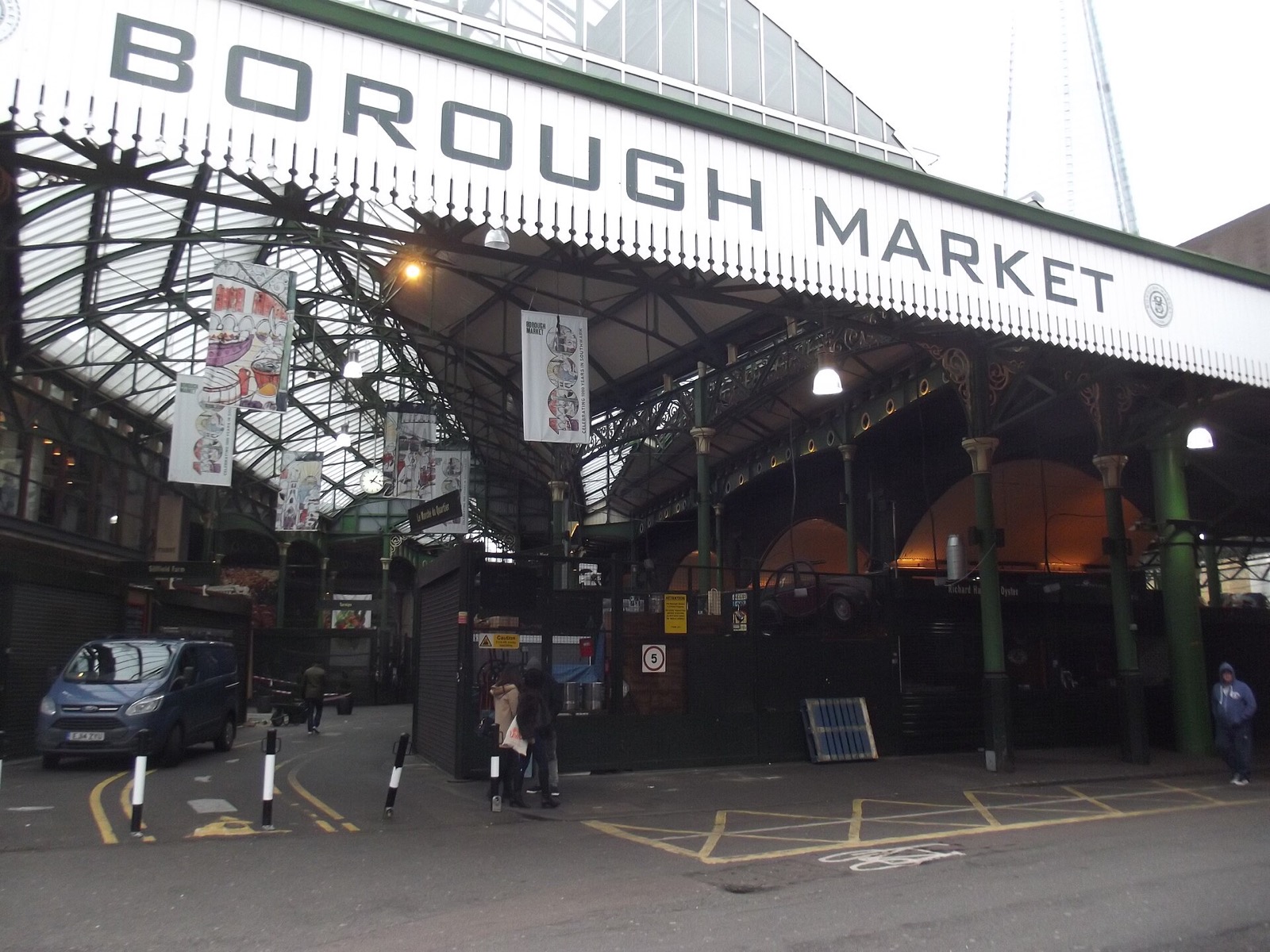 Borough Market under its green iron roof, with the railway bridge crossing above.