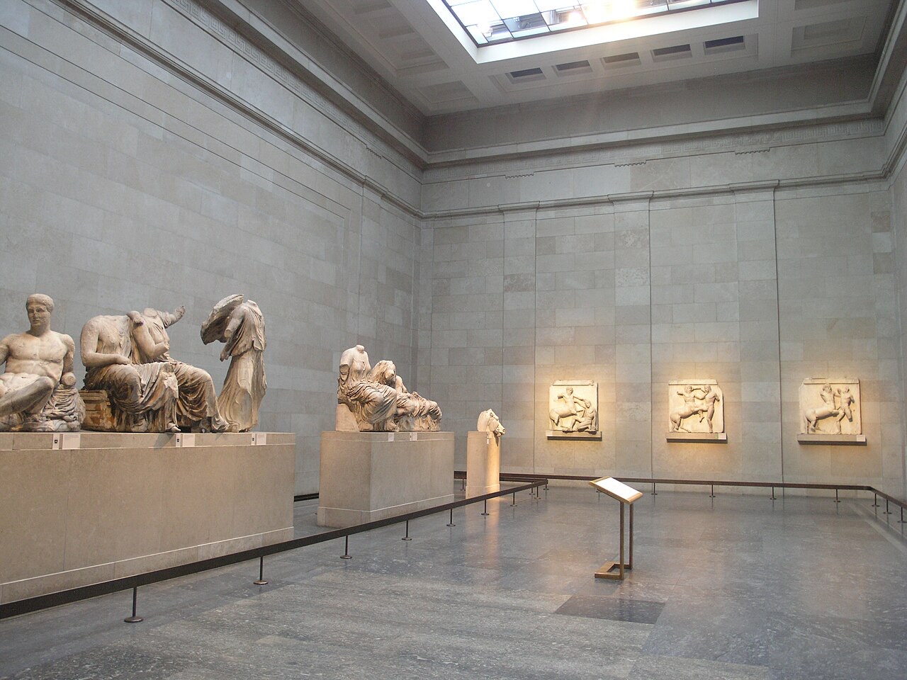 The gallery of the Parthenon sculptures at the British Museum, with figures from the pediments on low plinths.