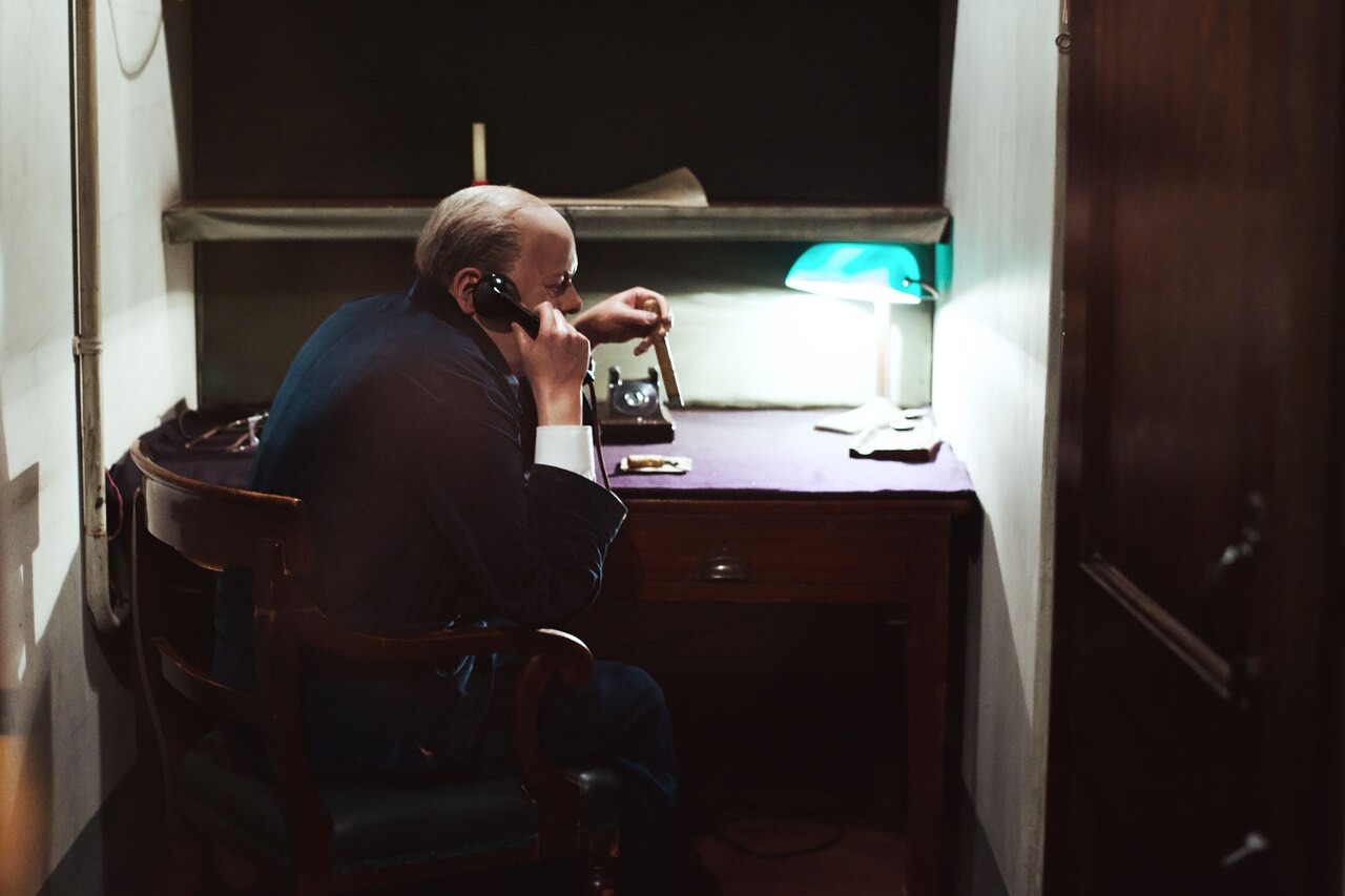 The small room of the transatlantic telephone in the Churchill War Rooms, with a figure of Churchill at the receiver.
