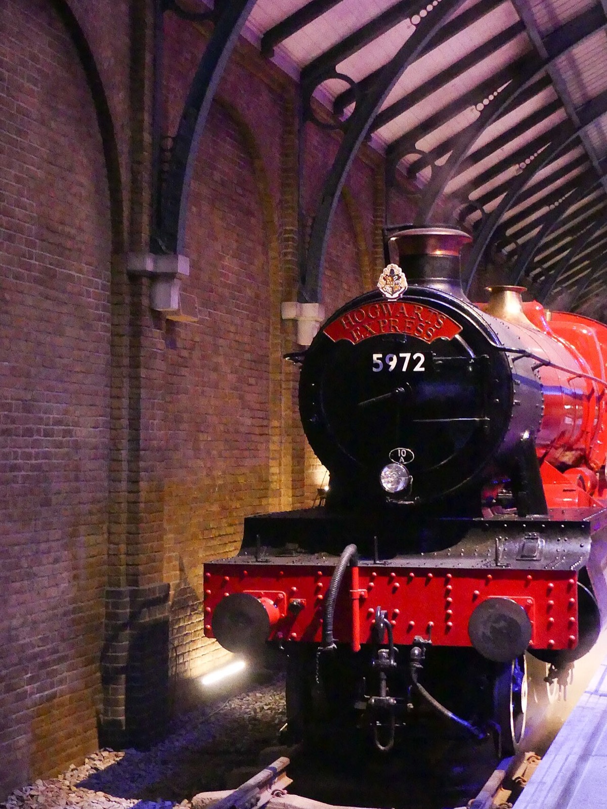 The red steam engine of the Hogwarts Express at its platform in the Warner Bros. Studio Tour London.