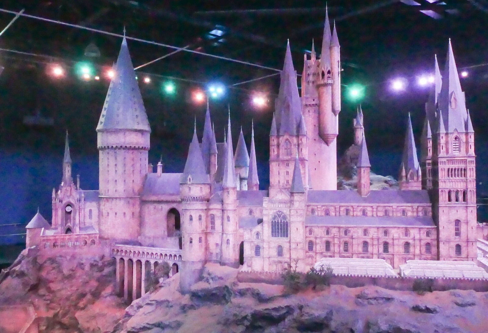 The model of Hogwarts castle at the Warner Bros. Studio Tour London, lit in violet.