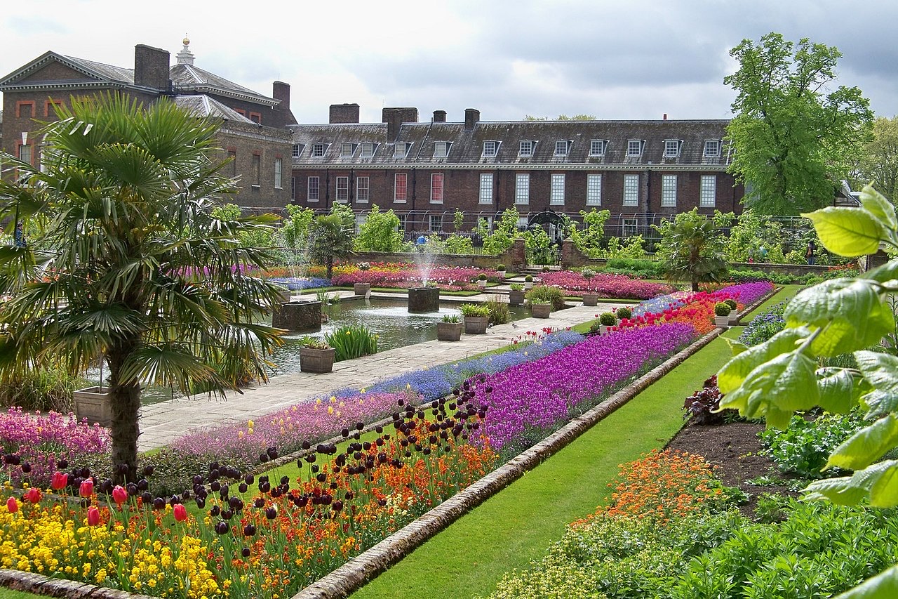 Kensington Palace seen over the flower beds and the pool of its Sunken Garden.