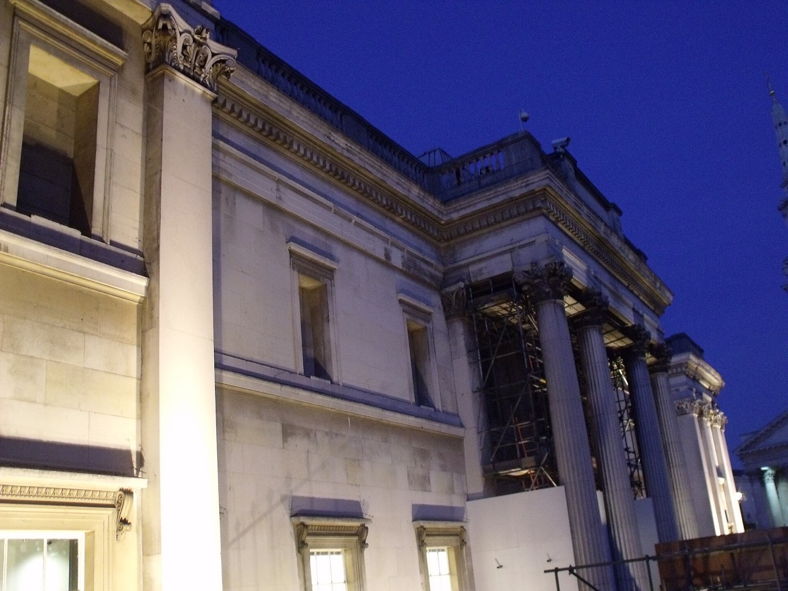 The portico of the National Gallery lit against a dark blue sky.