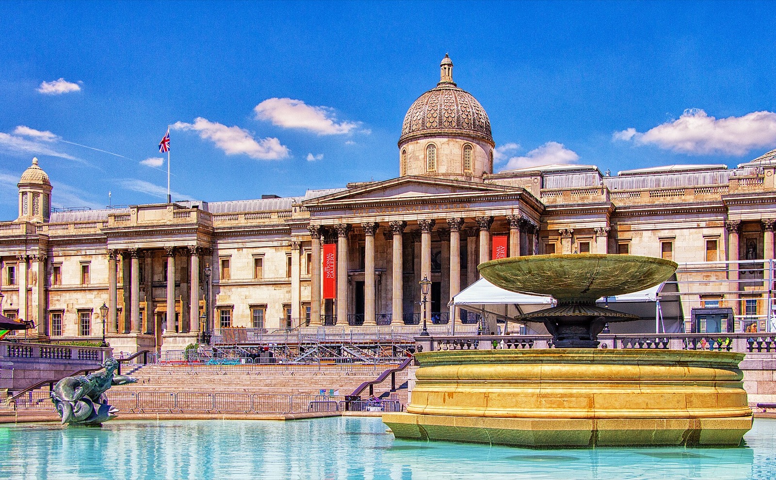 The National Gallery across Trafalgar Square, its columned portico and dome behind a fountain.
