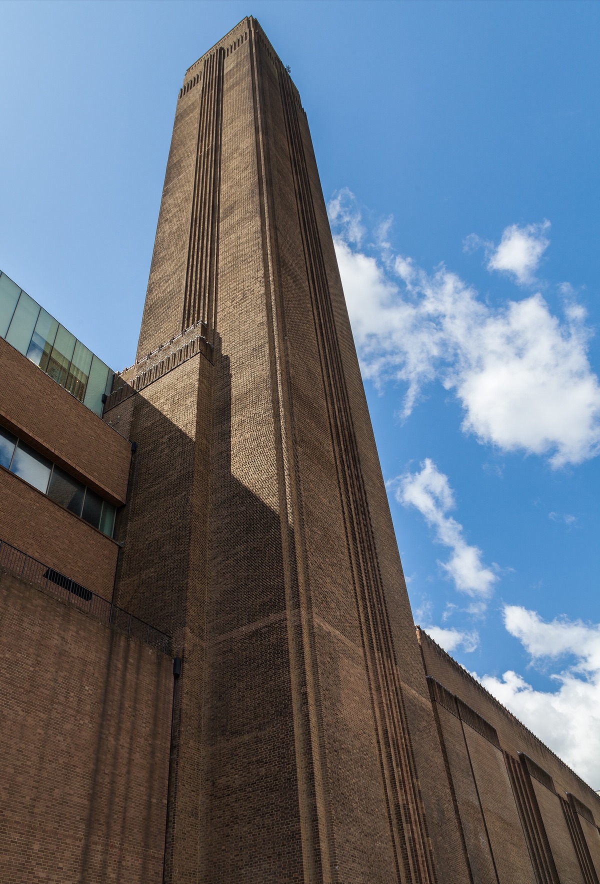 The brick chimney of Tate Modern against a blue sky.