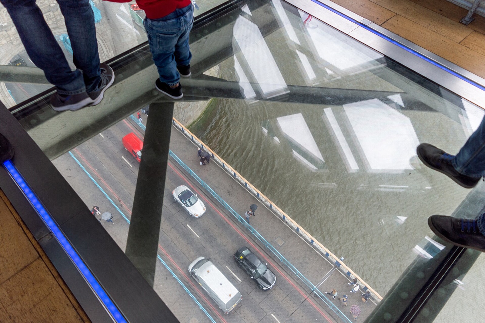The glass floor of the high walkway of Tower Bridge, with the road and the river far below.