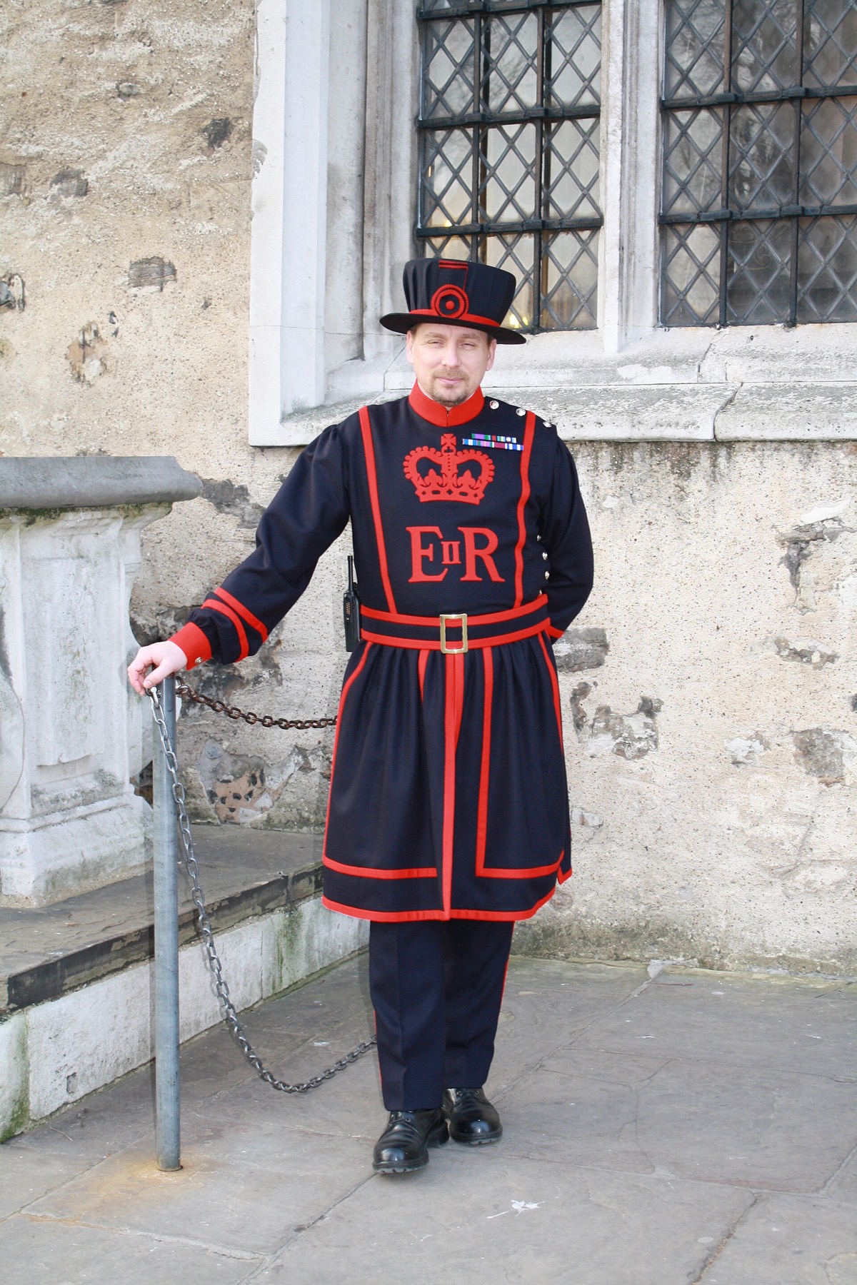 A Yeoman Warder of the Tower of London in his dark blue and red uniform.
