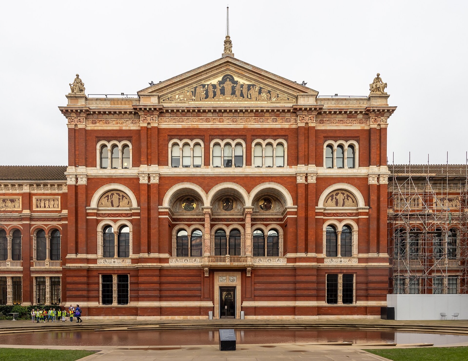 The red-brick and terracotta front of the Victoria and Albert Museum that faces its garden court.