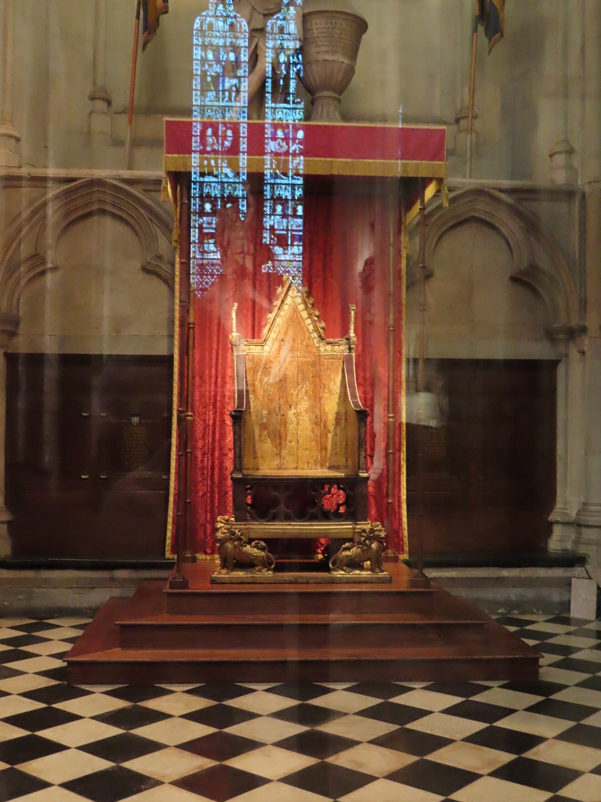 The Coronation Chair in Westminster Abbey, a high-backed wooden throne on a chequered floor.