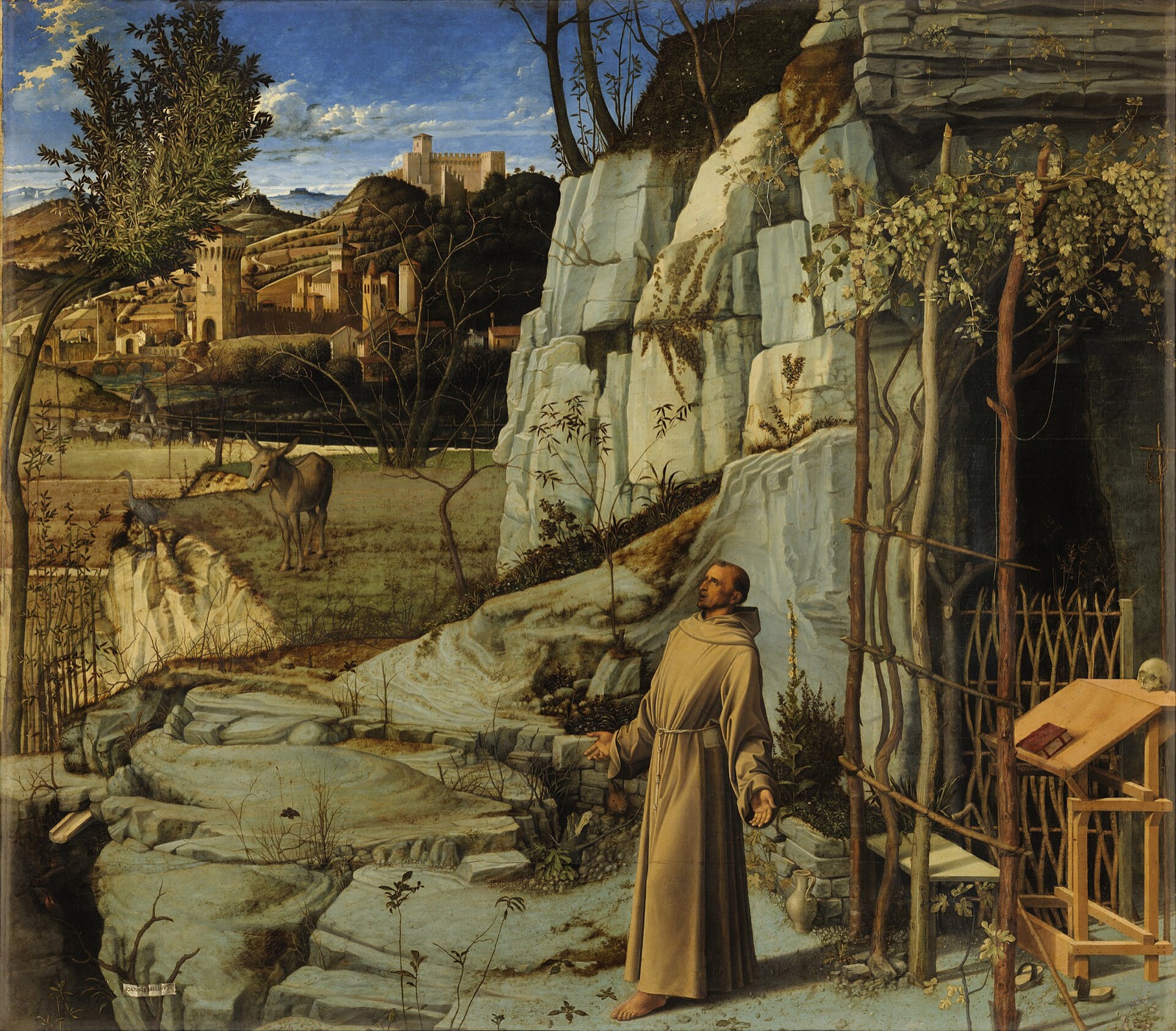 St Francis in the Desert by Giovanni Bellini: the saint standing barefoot outside his cell in a rocky landscape, his arms open to the light.