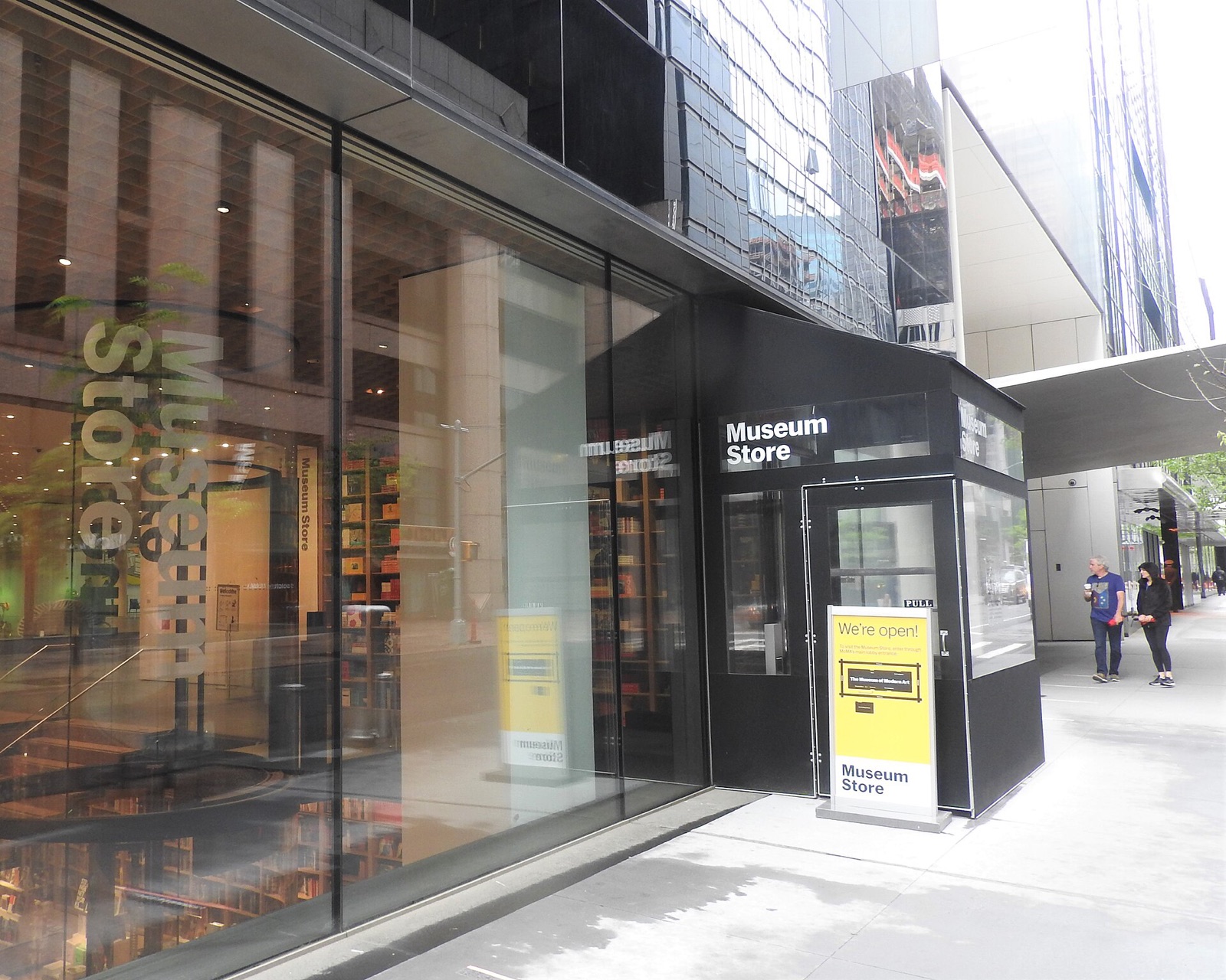 The glass front of the Museum of Modern Art on West 53rd Street, with the museum's shop beside the entrance.