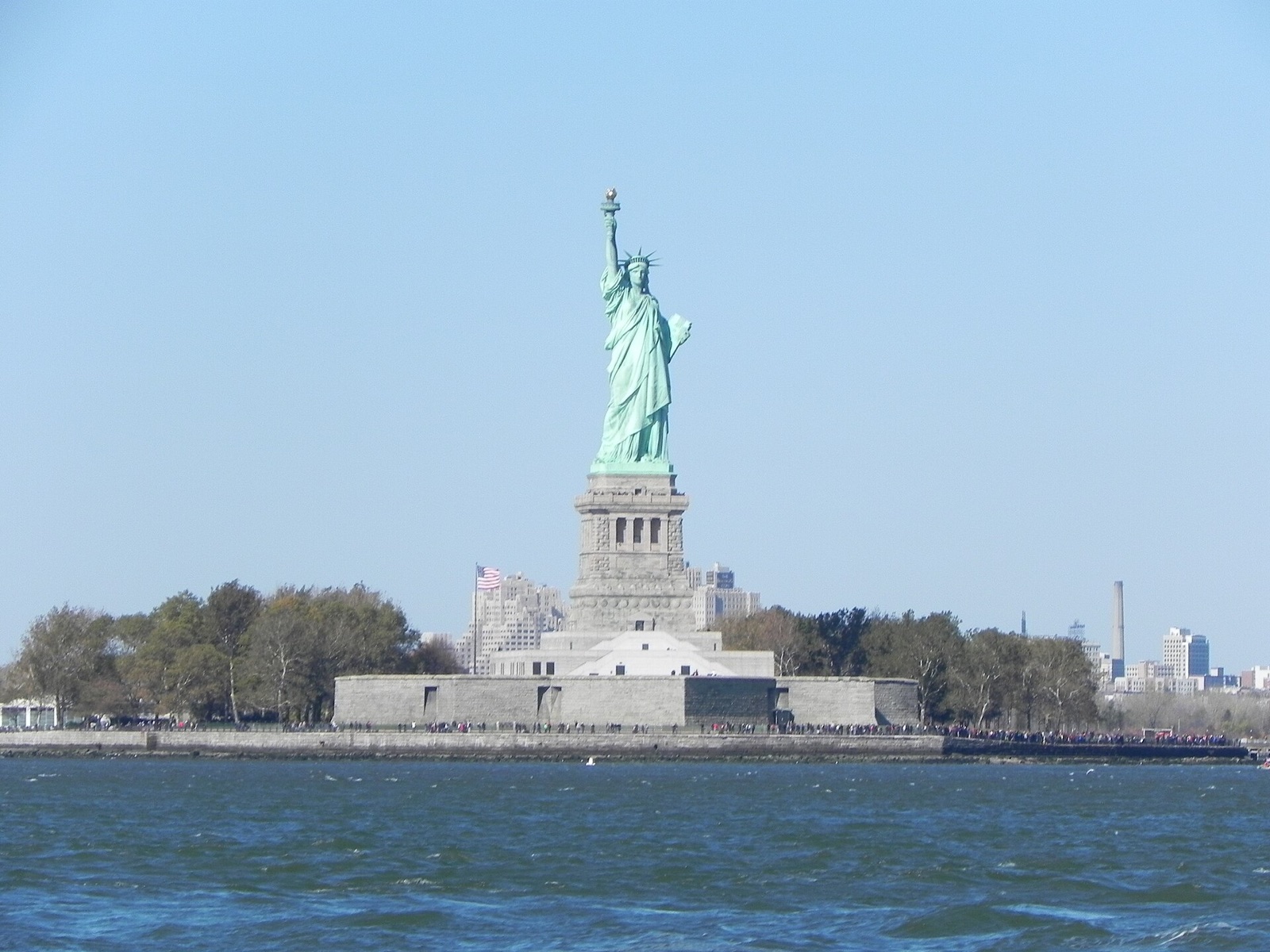 The Statue of Liberty on its island, seen across the water from the Staten Island Ferry.